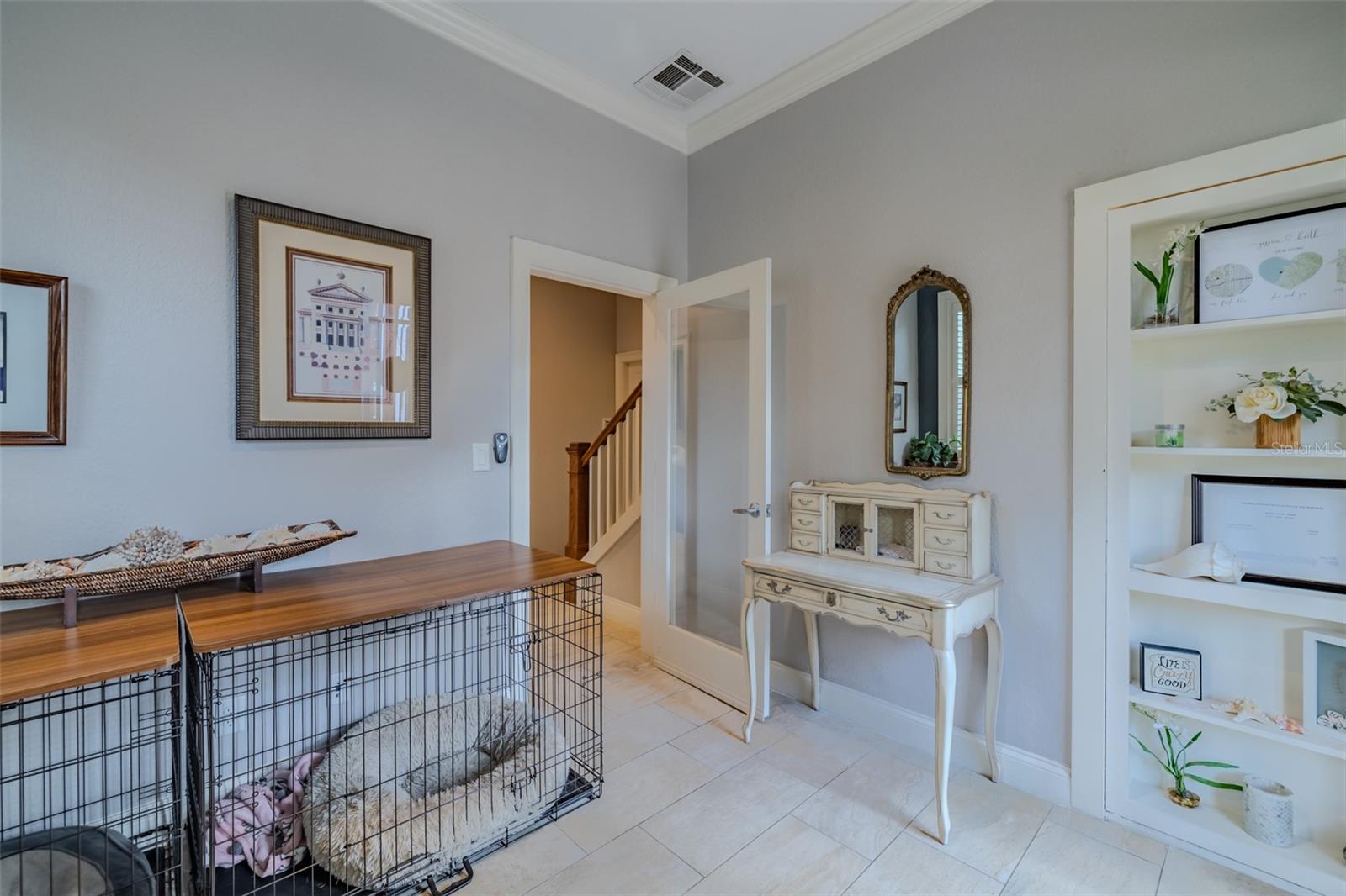 office with wine hidden behind book shelf