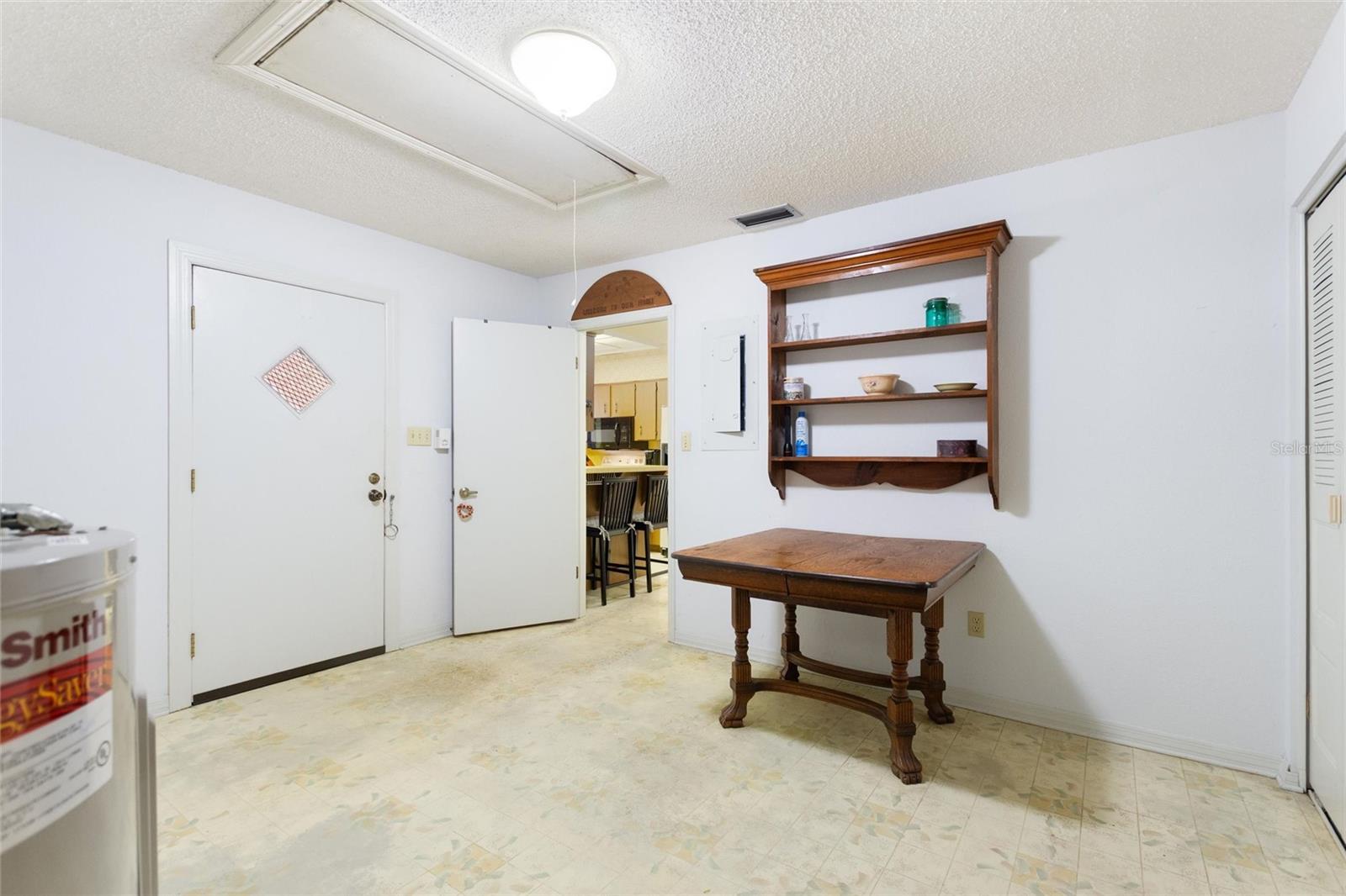 Laundry room has room for a computer area or small office.  Door to the left leads out to the carport area.