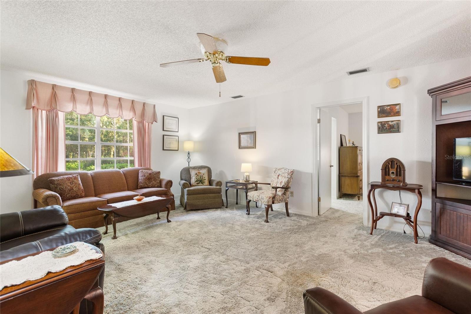 Living room has more than ample space.  Doorway leads into one of two master bedroom suites.