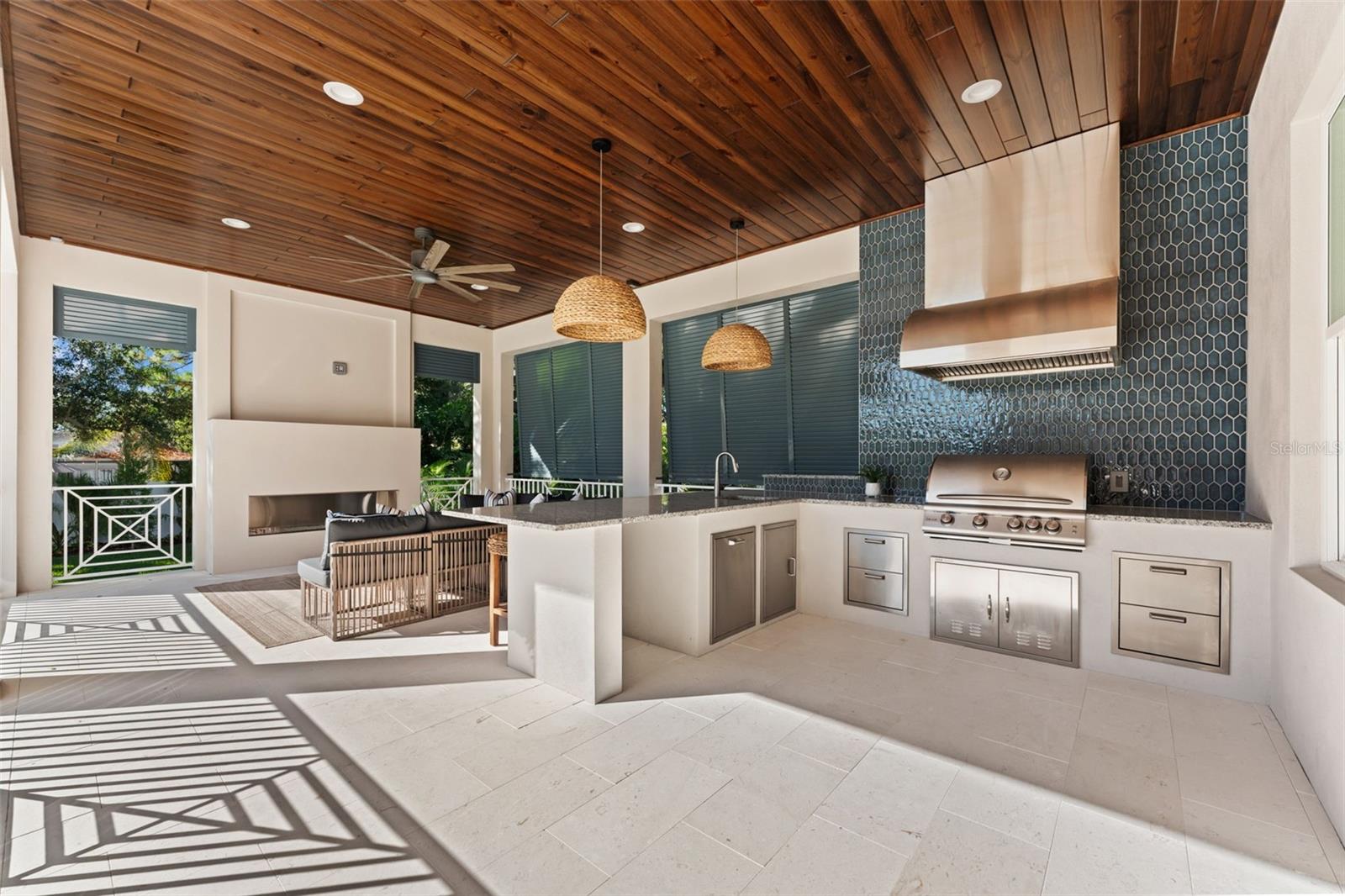 Outdoor kitchen, living space, fireplace.