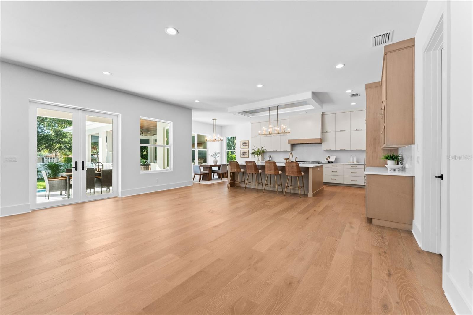 Open living and kitchen with access to backyard.