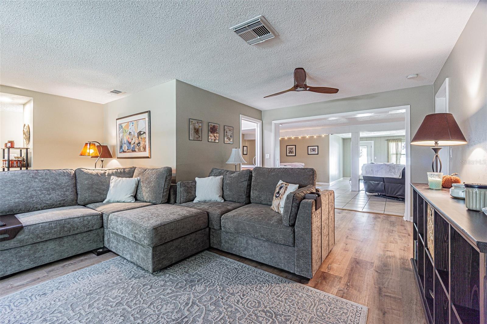 Spacious living room looking into flex space that could be utilized as a dining room and the family room beyond.