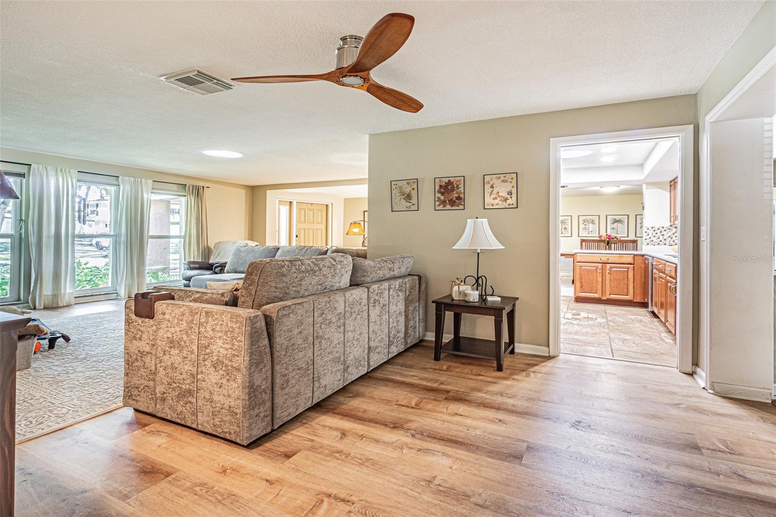 Additional flex space adjacent to the living room looking into the kitchen which could be used as a dining room.