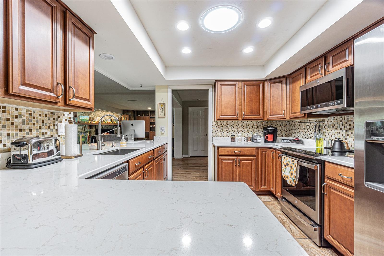 Custom kitchen with ample quartz counter space.
