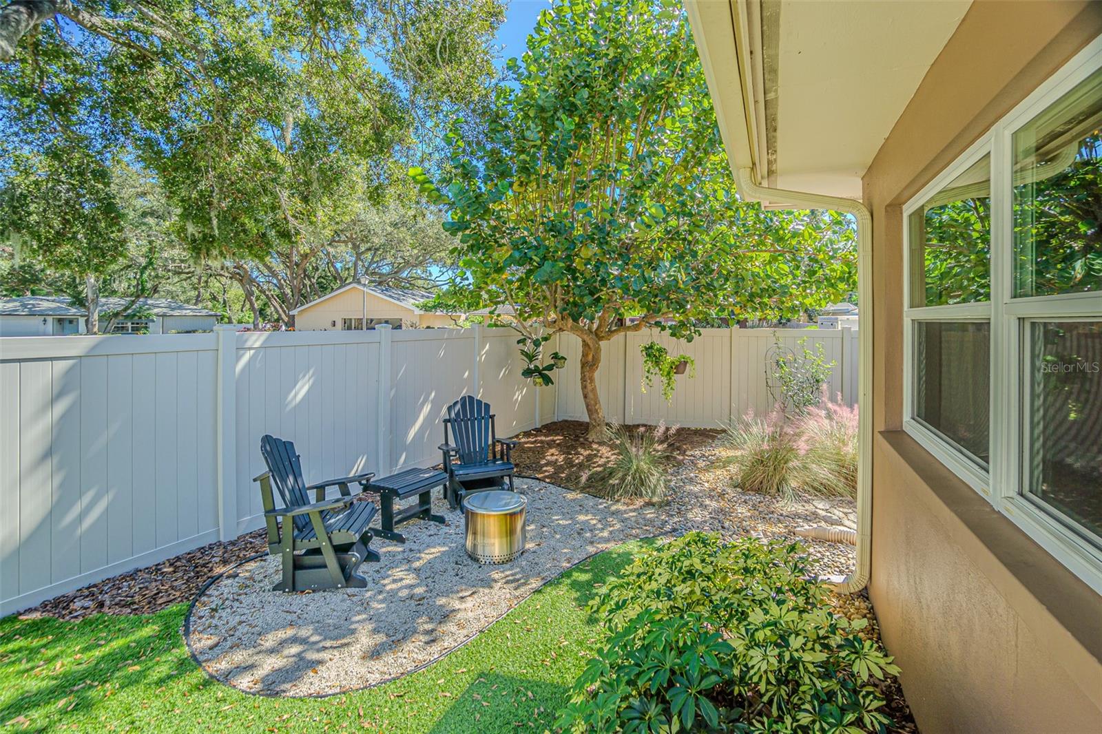 Backyard seating areas with artificial turf.