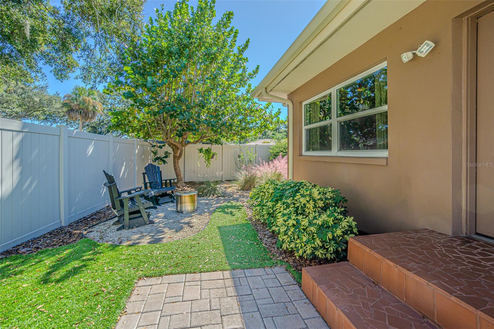 Backyard seating areas with artificial turf.