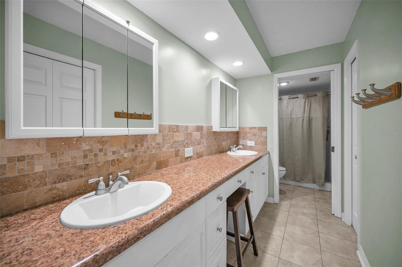 Primary bathroom with double sinks and mirrors