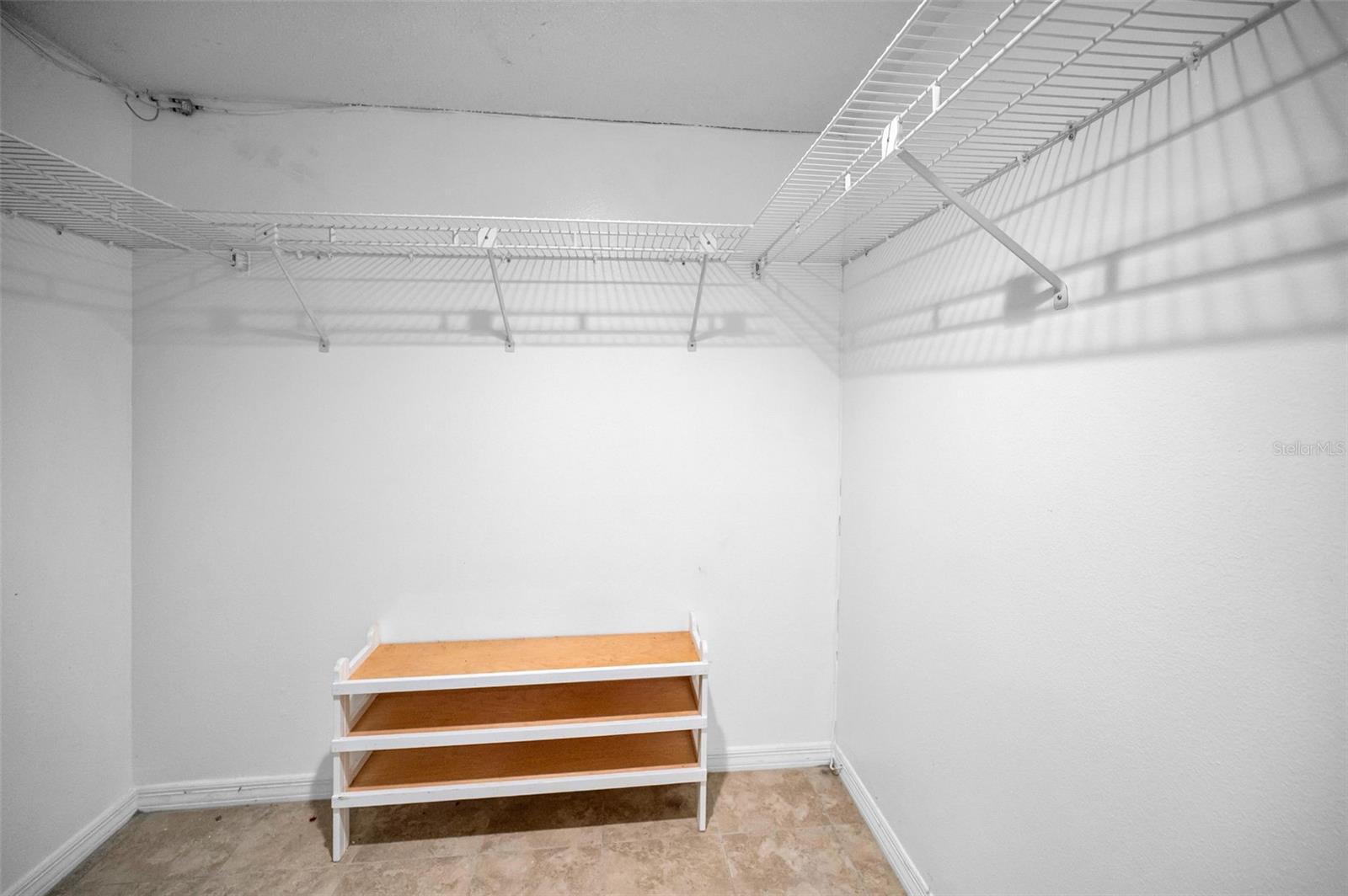 Primary bedroom walk in closet