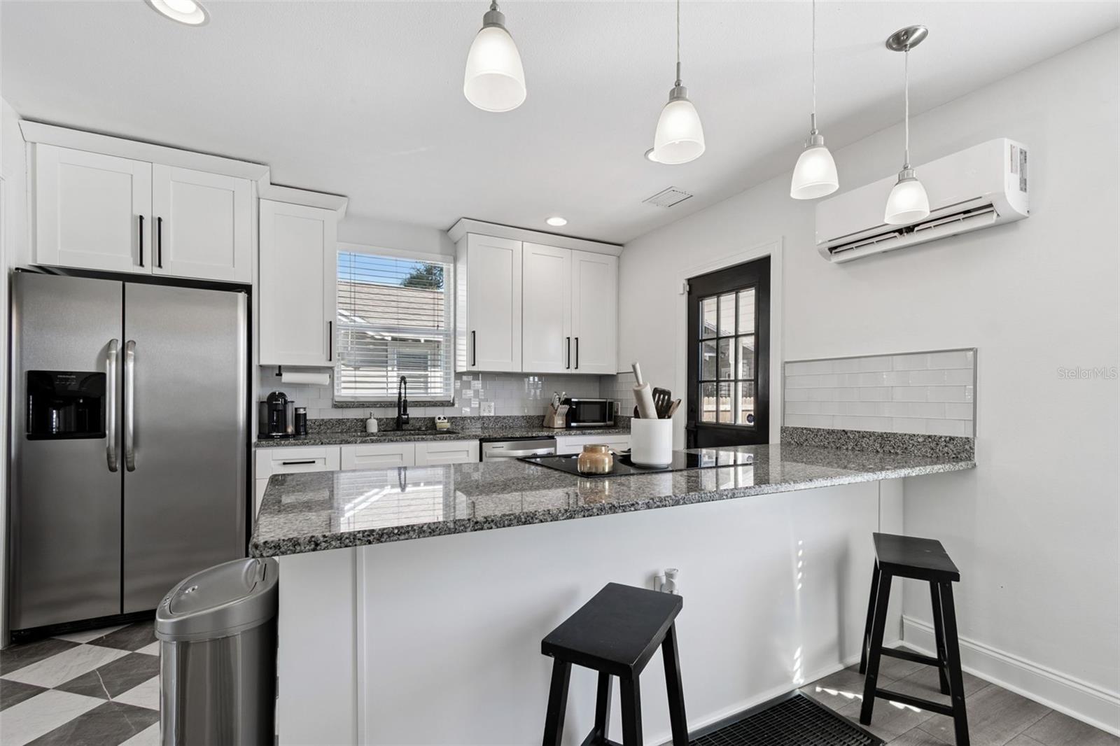 Counter seating in kitchen allows for conversation while entertaining