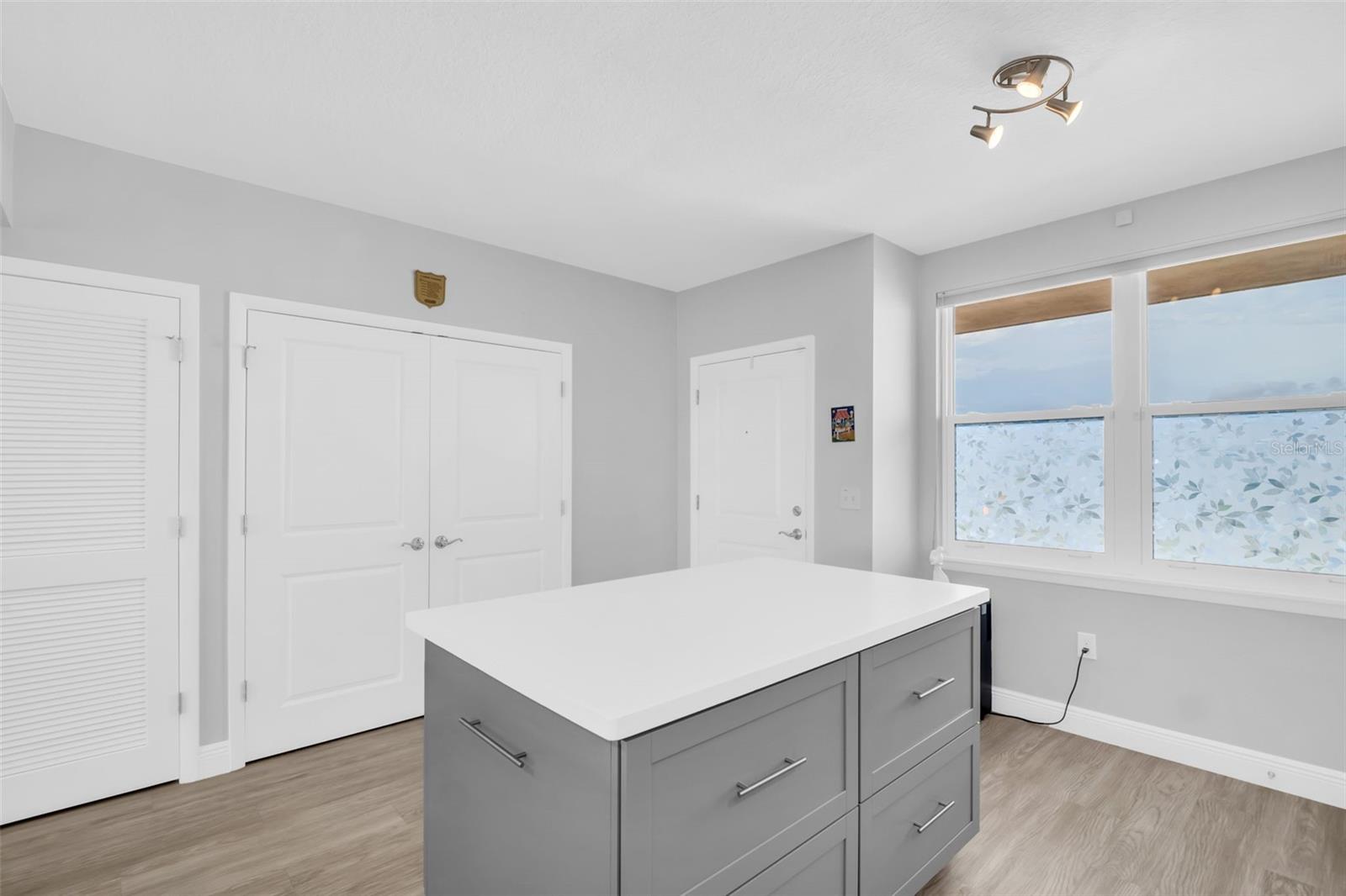 Kitchen Island Facing Entrance and Laundry Closet