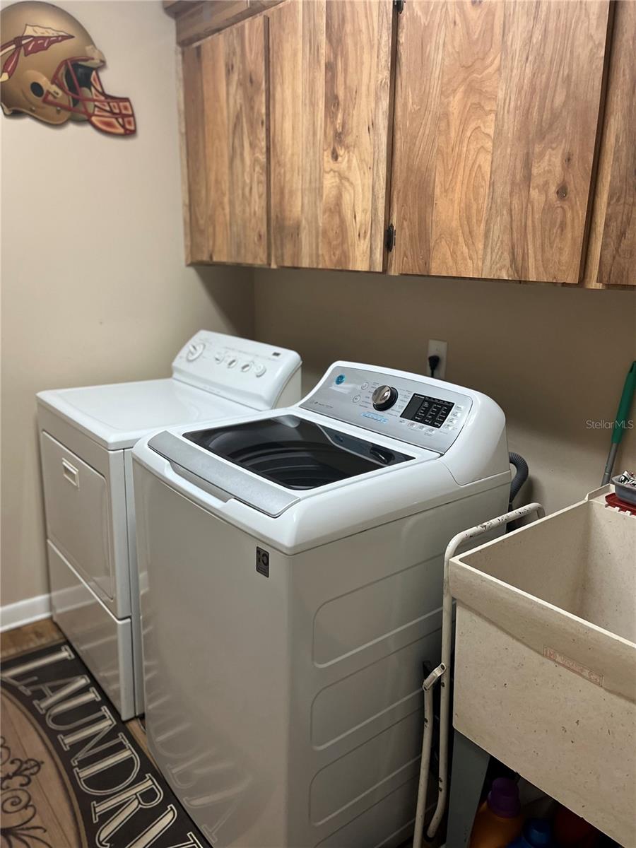 Inside laundry with utility sink and storage