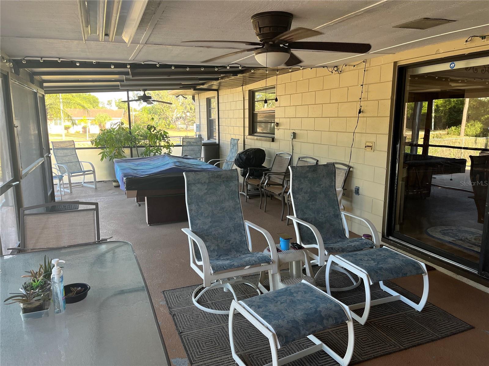 Screened patio across the back of home overlooks pool