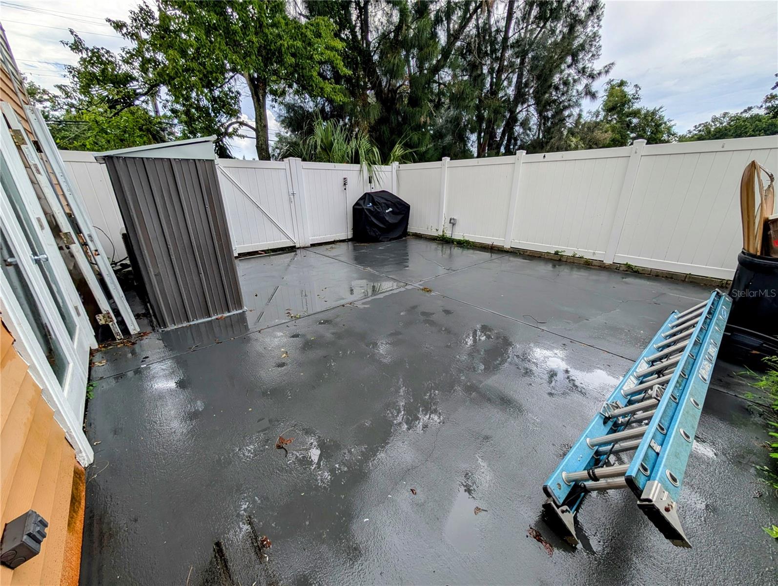 Fenced Concrete Patio and Storage Shed