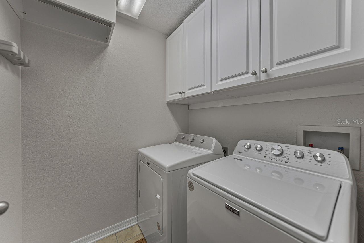 Large Laundry room with storage cabinets.
