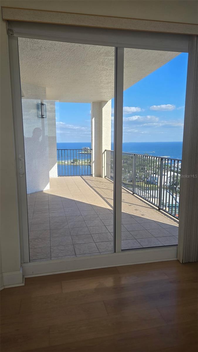 View eastward from primary bedroom though sliding doors to the balcony