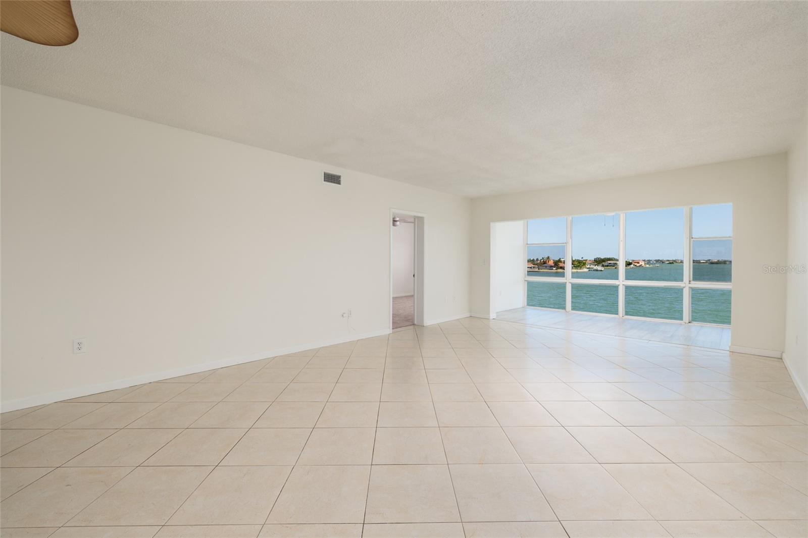 Living/Dining area, Florida room & doorway to primary bedroom.
