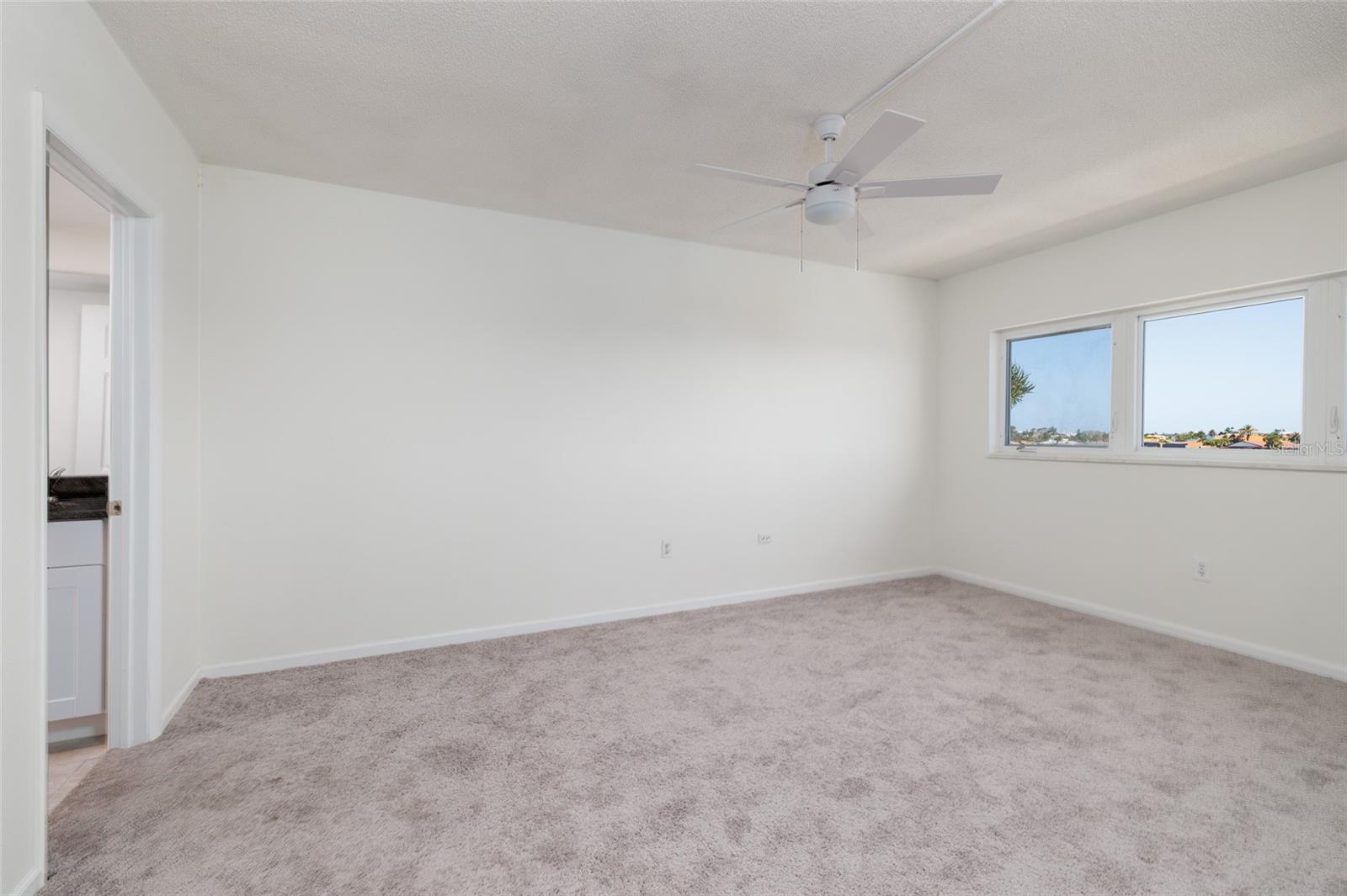 Primary bedroom (12'x16') w/Bay views & en-suite bathroom on left. Large walk-in Closet.