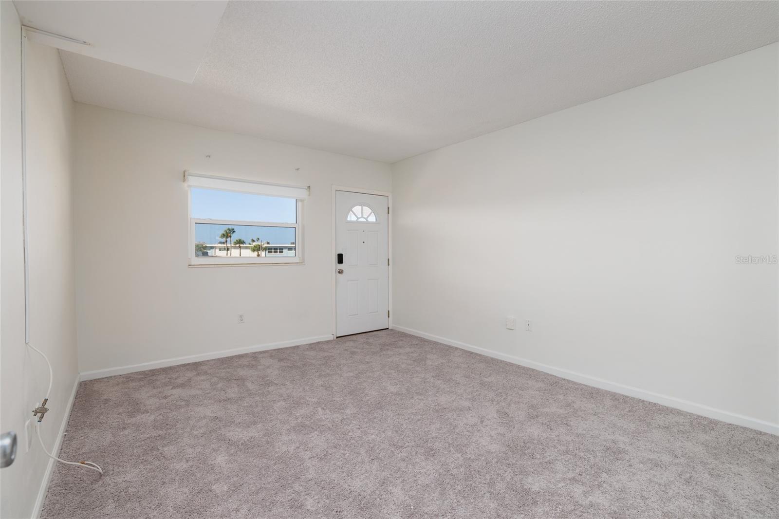 2nd bedroom (12'x14') & door to the front covered walkway/porch.