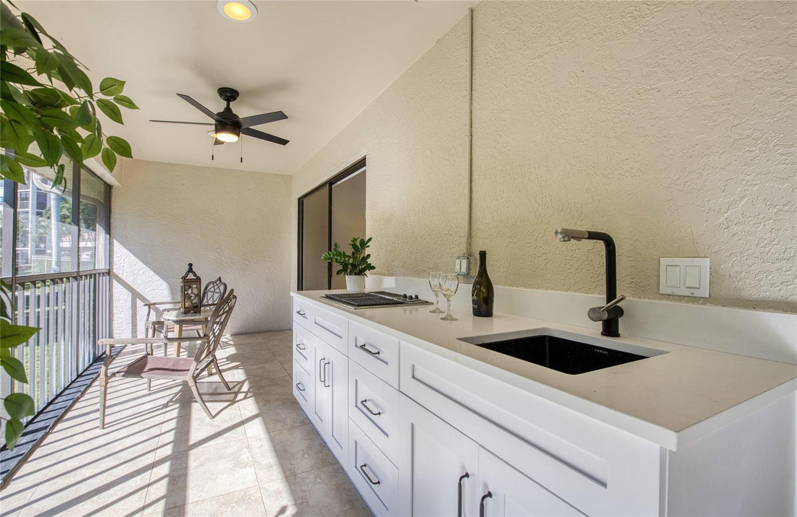 Large Lanai with cook top facing the marina