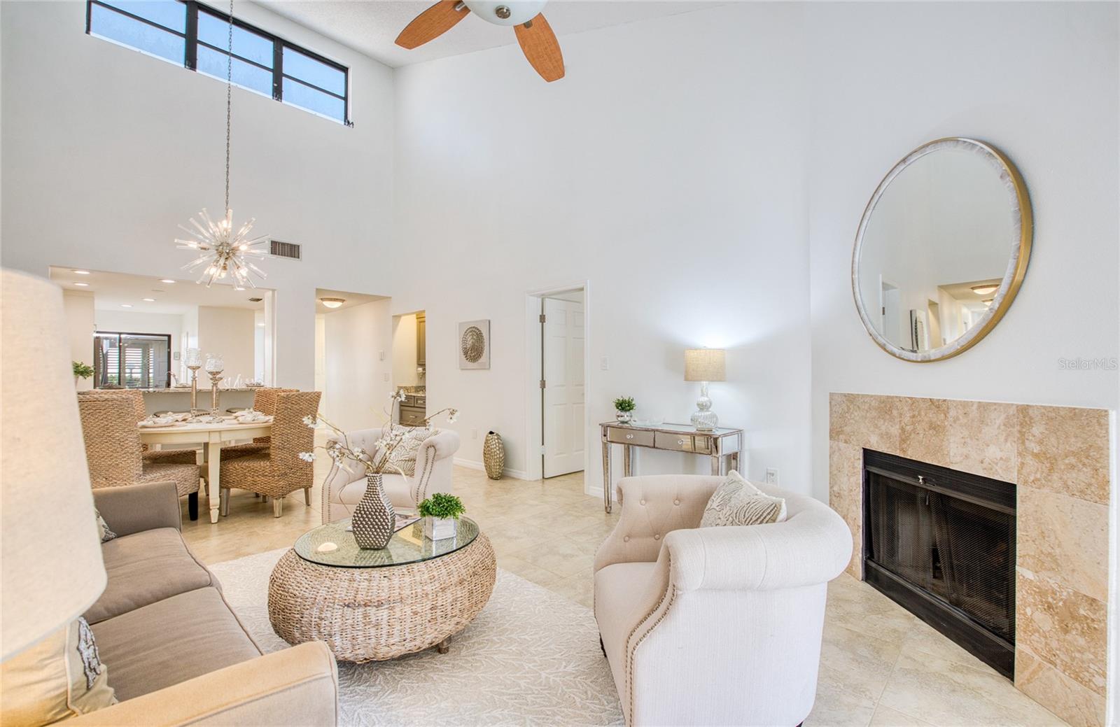 High ceilings in living/dining room  with wood burning fireplace