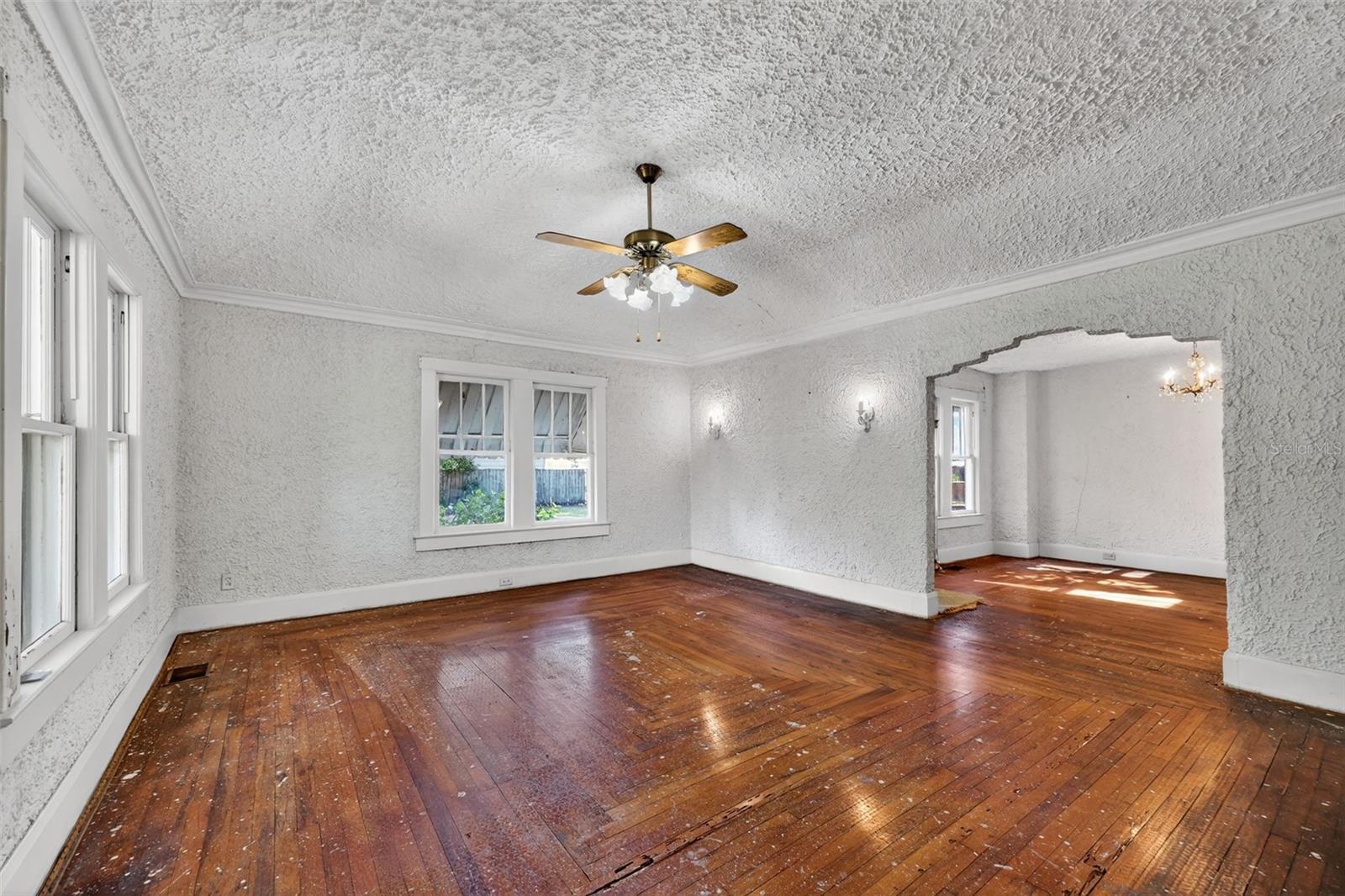 Notice the 1928 craftmanship and detailed pattern of the narrow boards in the living room and dining room.  The carpet was just pulled up after 40 years of covering the floors.  There are old paint splatters and some repairs to be made, but once refinished, will look magnificent!