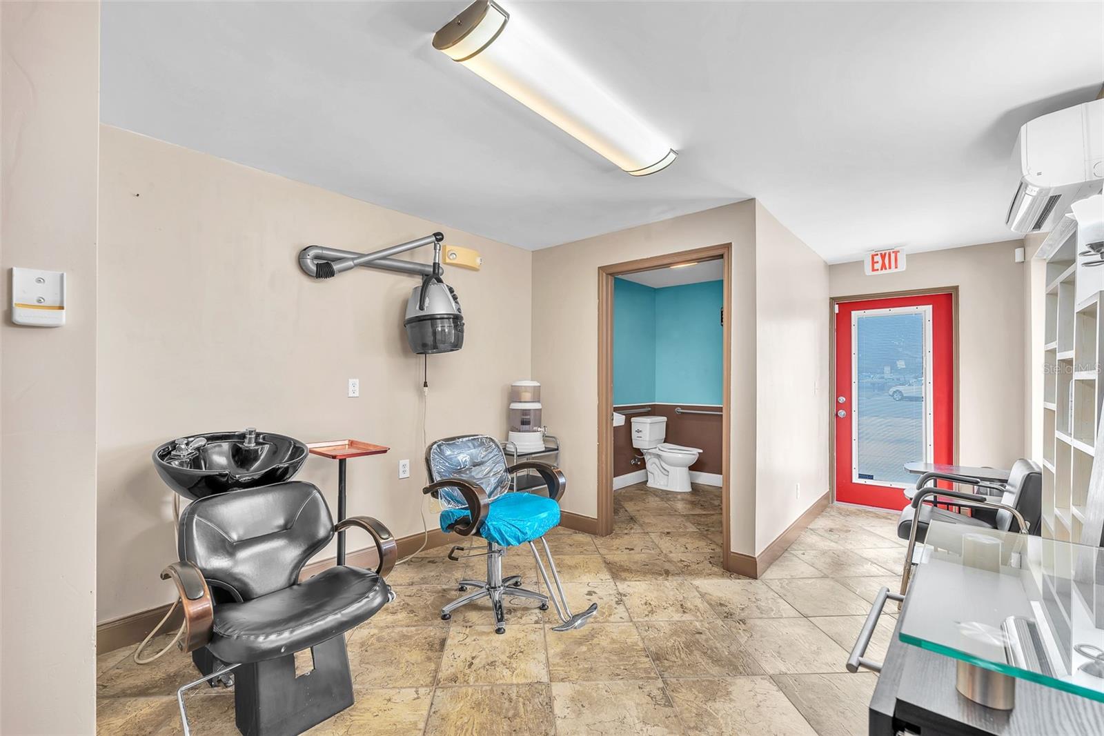 The professionally built business suite includes a private entrance, dedicated AC system, impact-resistant windows and door, and full ADA compliance — completely furnished and ready for your salon, studio, or rental tenant.
