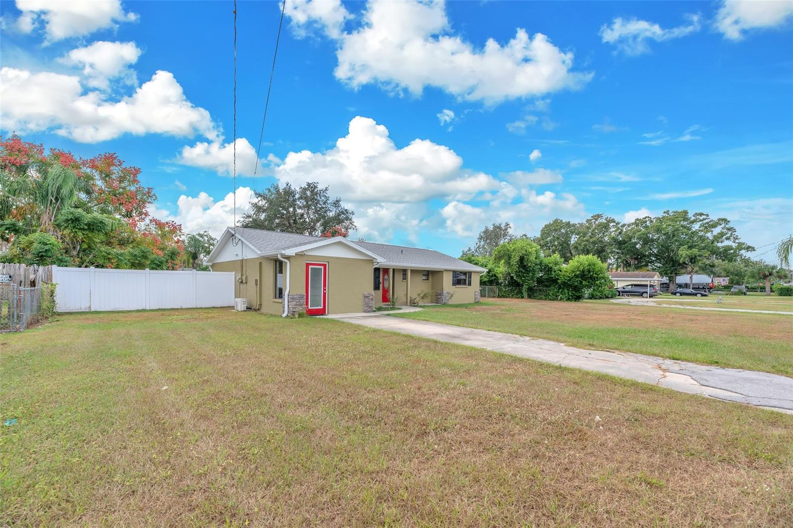 The yard is completely fenced and the long driveway can accomodate several vehicles.