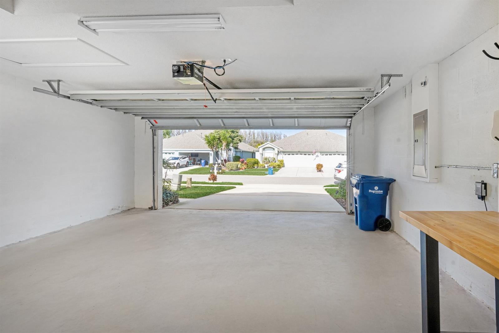 GARAGE VIEW WITH WORK TABLE AND SHELVING