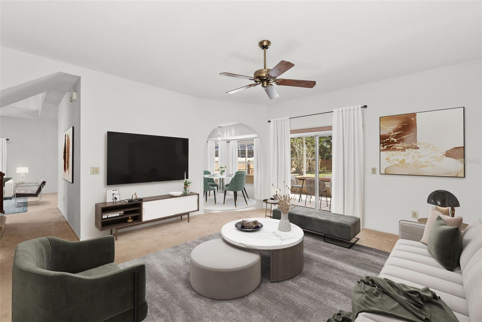 Family room adjacent to eat-in kitchen and HUGE covered lanai with view of lovely, expansive backyard.