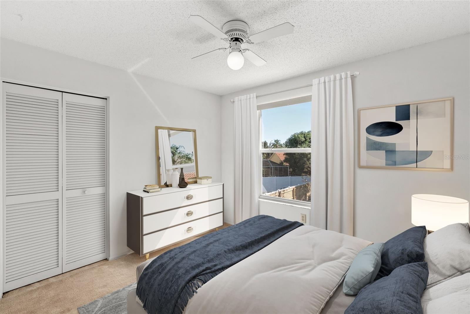Sunny bedroom 2 with view of lovely backyard.