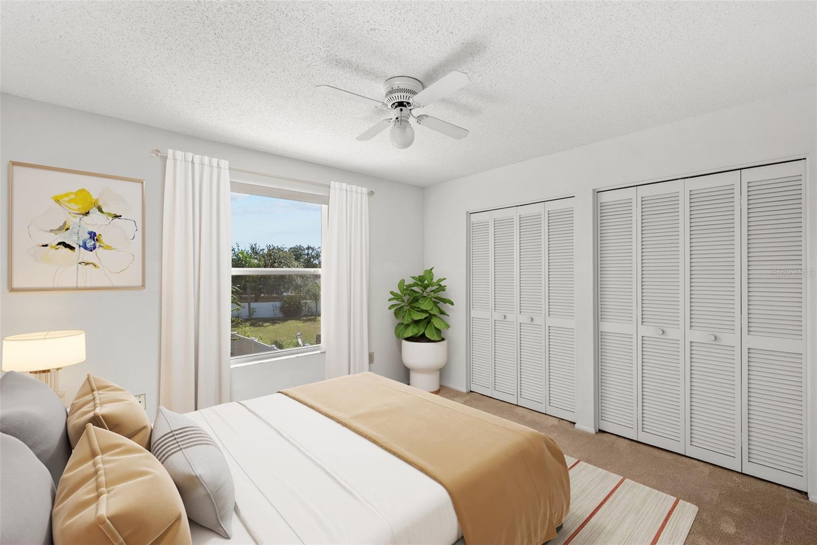 Bedroom 3 with full wall of closets and view of lovely backyard.
