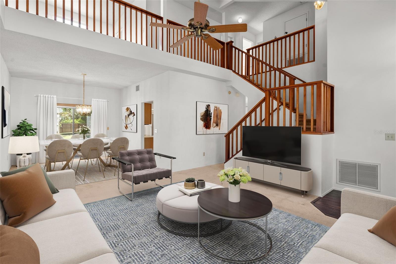 Bright and open!    Front living room and dining room with cathedral ceilings, upstairs bonus room (upper left) and view of pretty backyard.