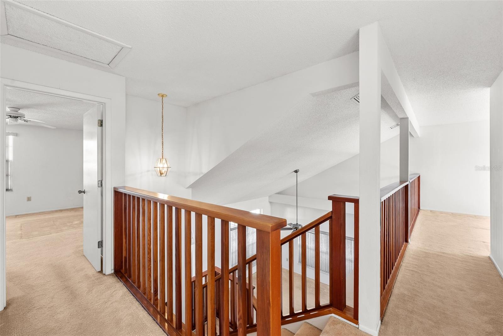 View of upstairs hallways - Master BR to left, bonus room to right