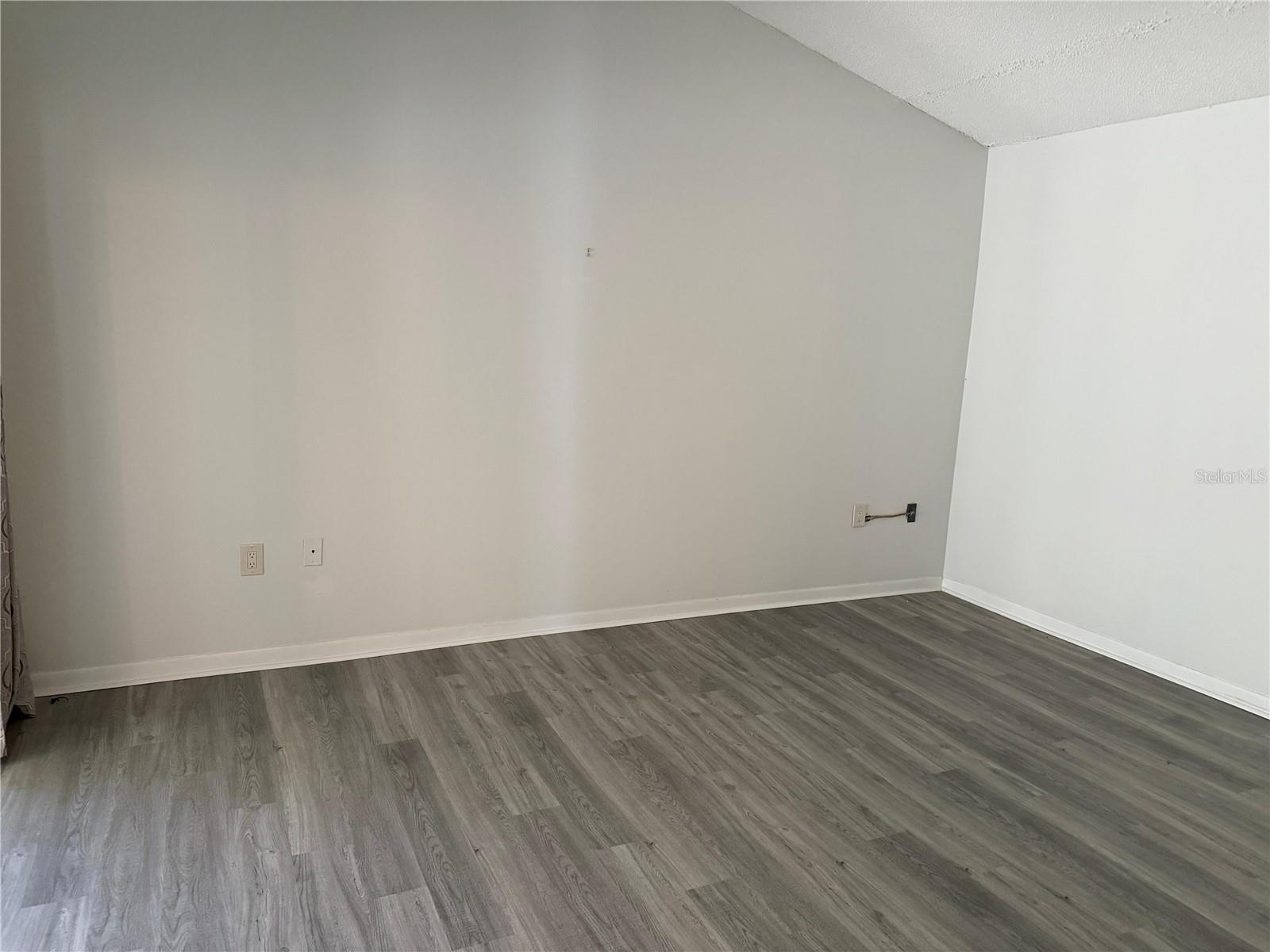 Primary bedroom with vaulted ceiling.