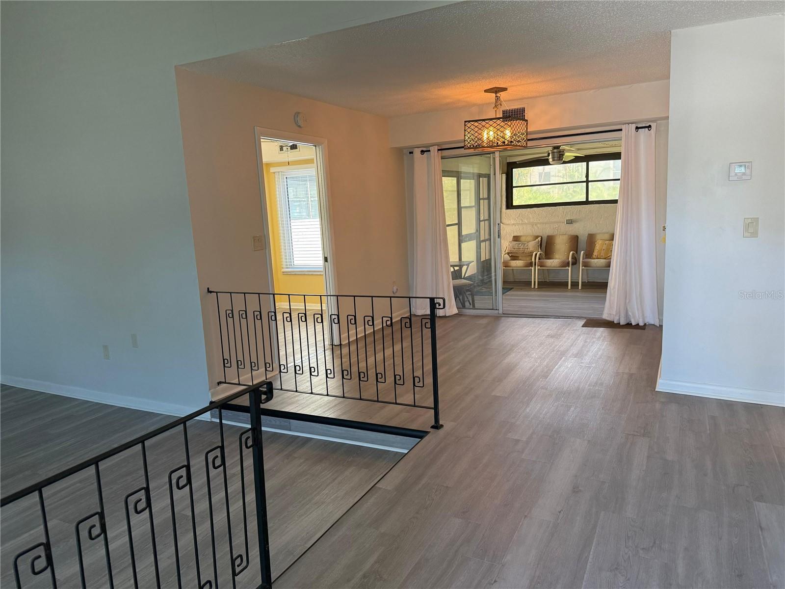 Entry foyer living room on the left, dining room, enclosed porch straight ahead,  and the eat in kitchen to the left.