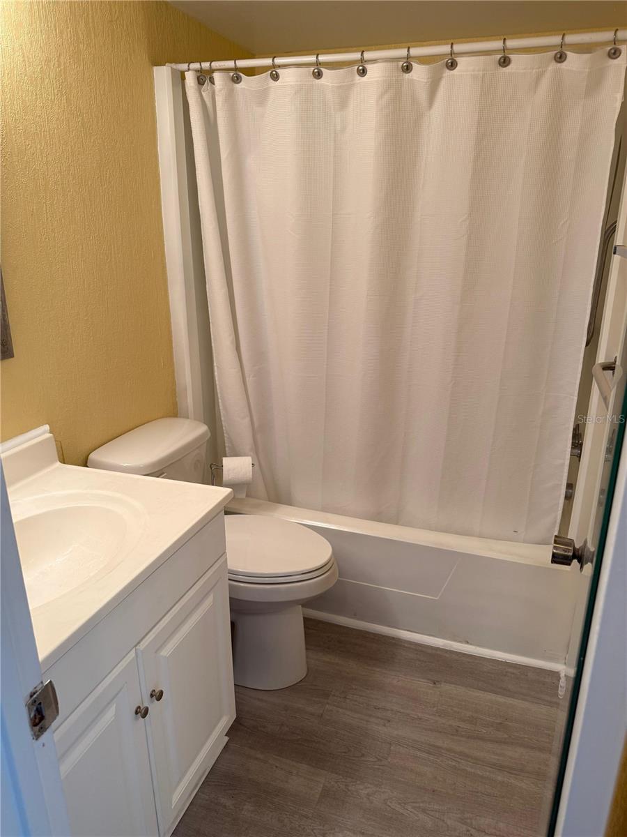 Guest bathroom has a tub.