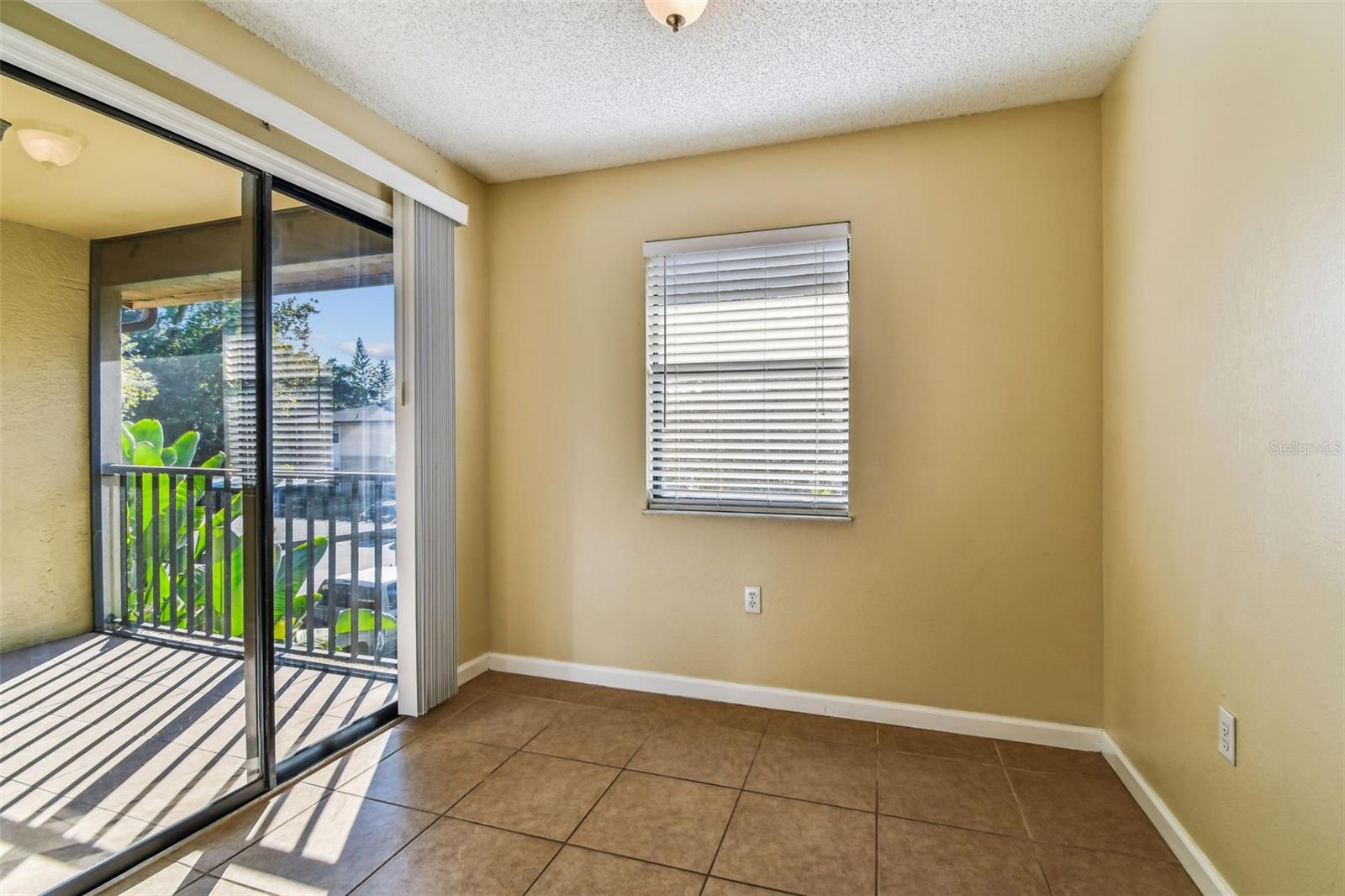 Dining room space, front side of condo. Sliders leading out to screened in patio on front.