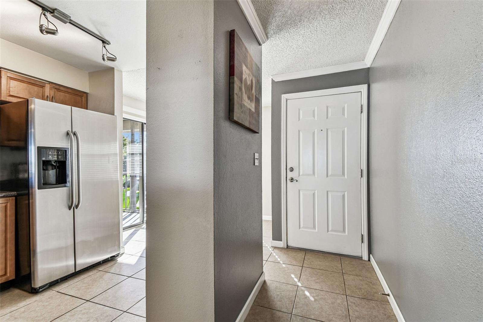 Front door and kitchen space.
