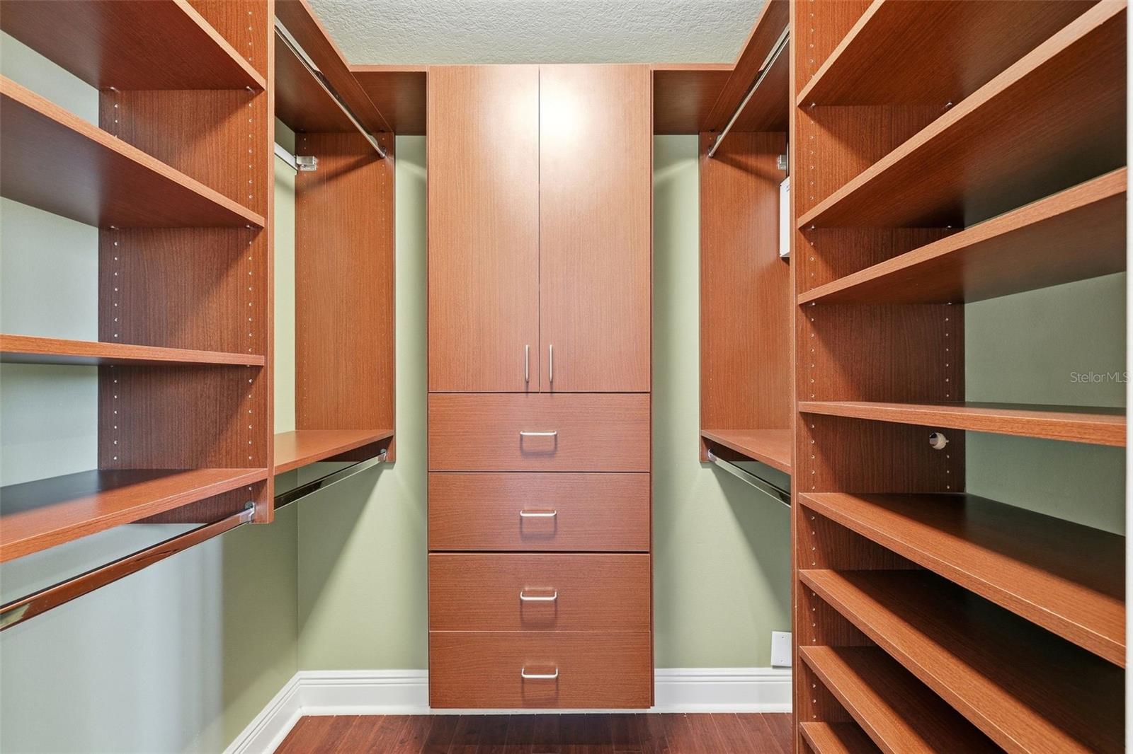 one of two primary bedroom walk in closets