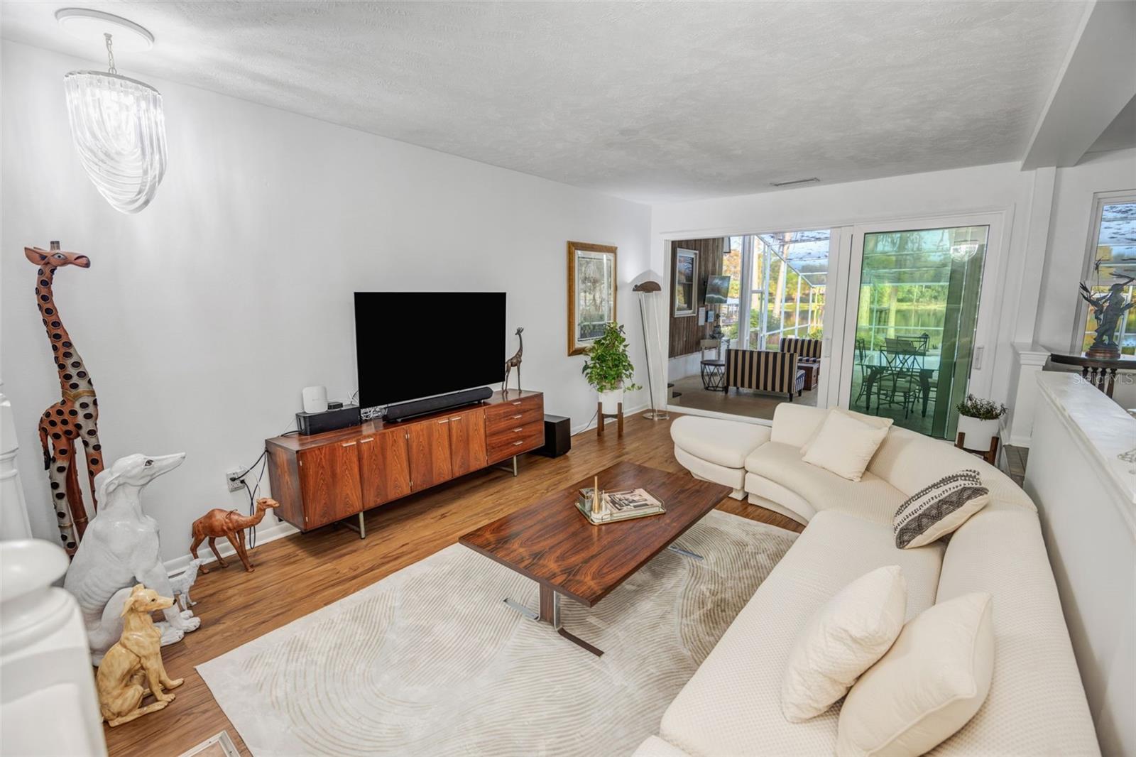 Sunken living room leads to the wide open sliding doors