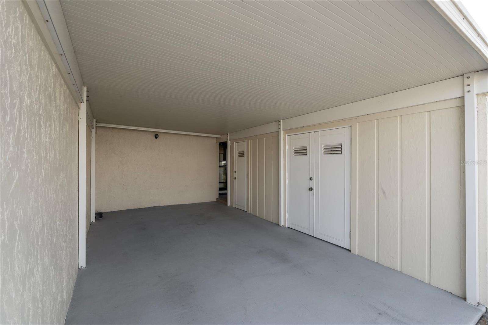 Private covered carport with 2 storage units