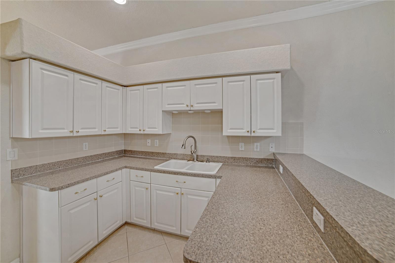 KITHCEN WITH OVERHEAD LIGHTING, NEWER SS APPLIANCES AND BREAKFAST BAR