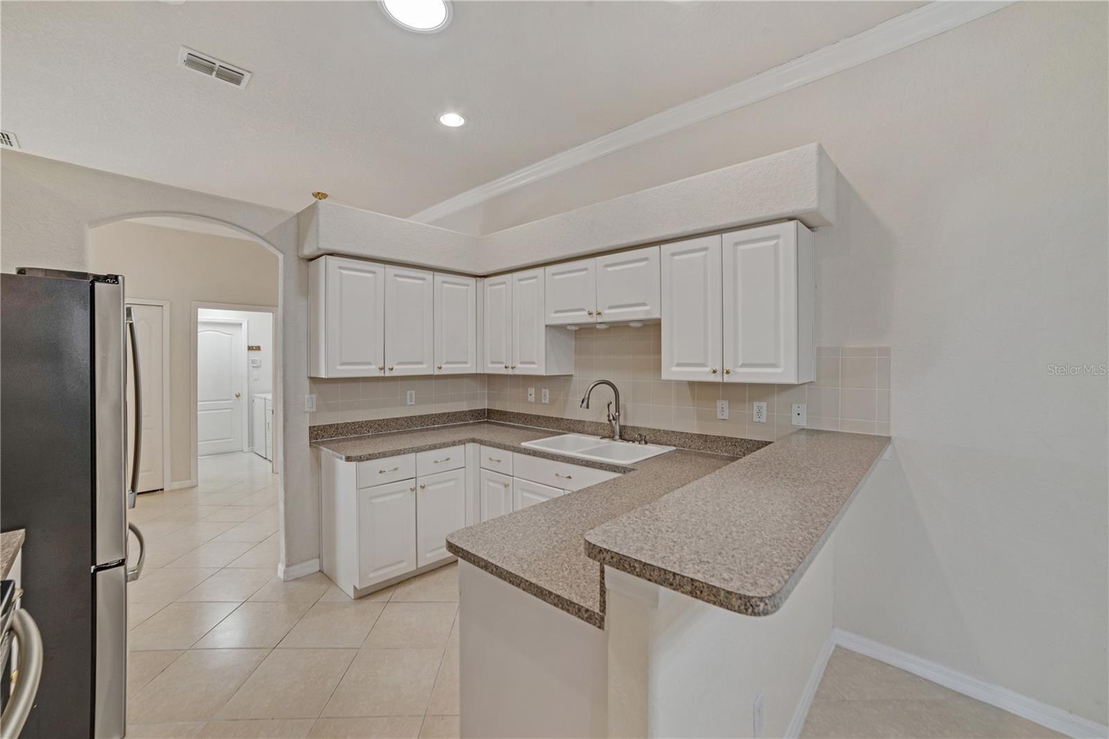EASY FOOD PREP IN THIS WELL-DESIGNED KITCHEN WHICH ADJOINS THE DINING/FLEX ROOM AND GREAT ROOM