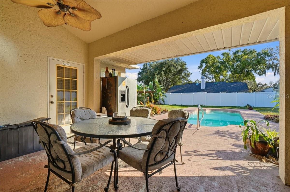 Covered back lanai overlooking pool and spacious backyard