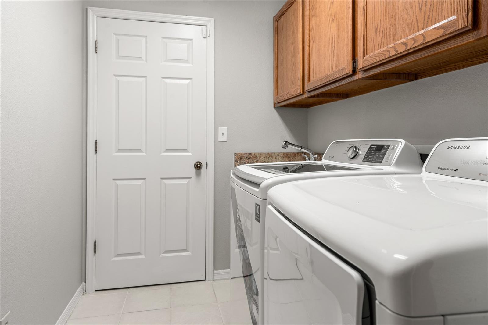 Laundry room w/ sink, washer and dryer included