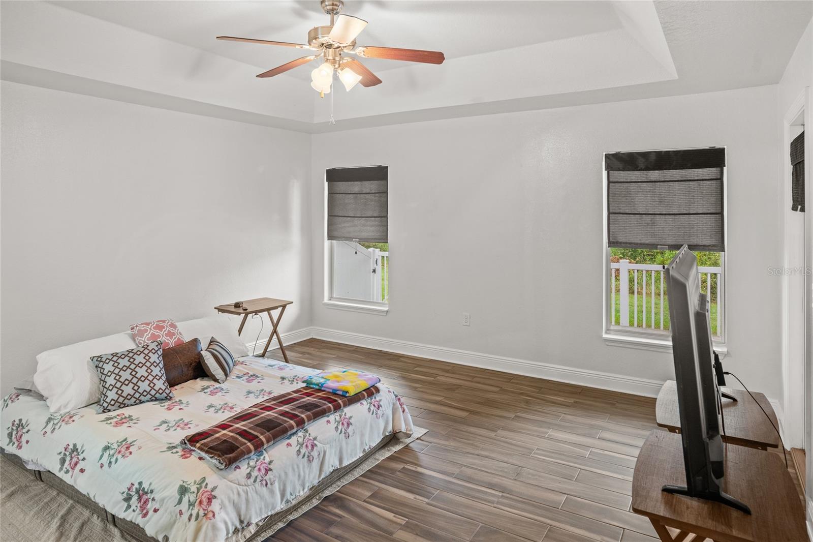 Primary bedroom with direct access to the screened in patio.
