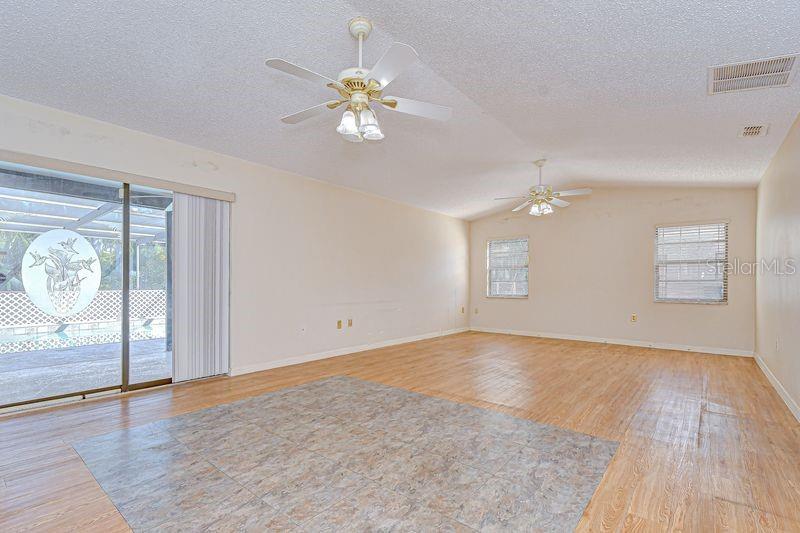 Great Room opens to the Screened Lanai w/Pool and Backyard