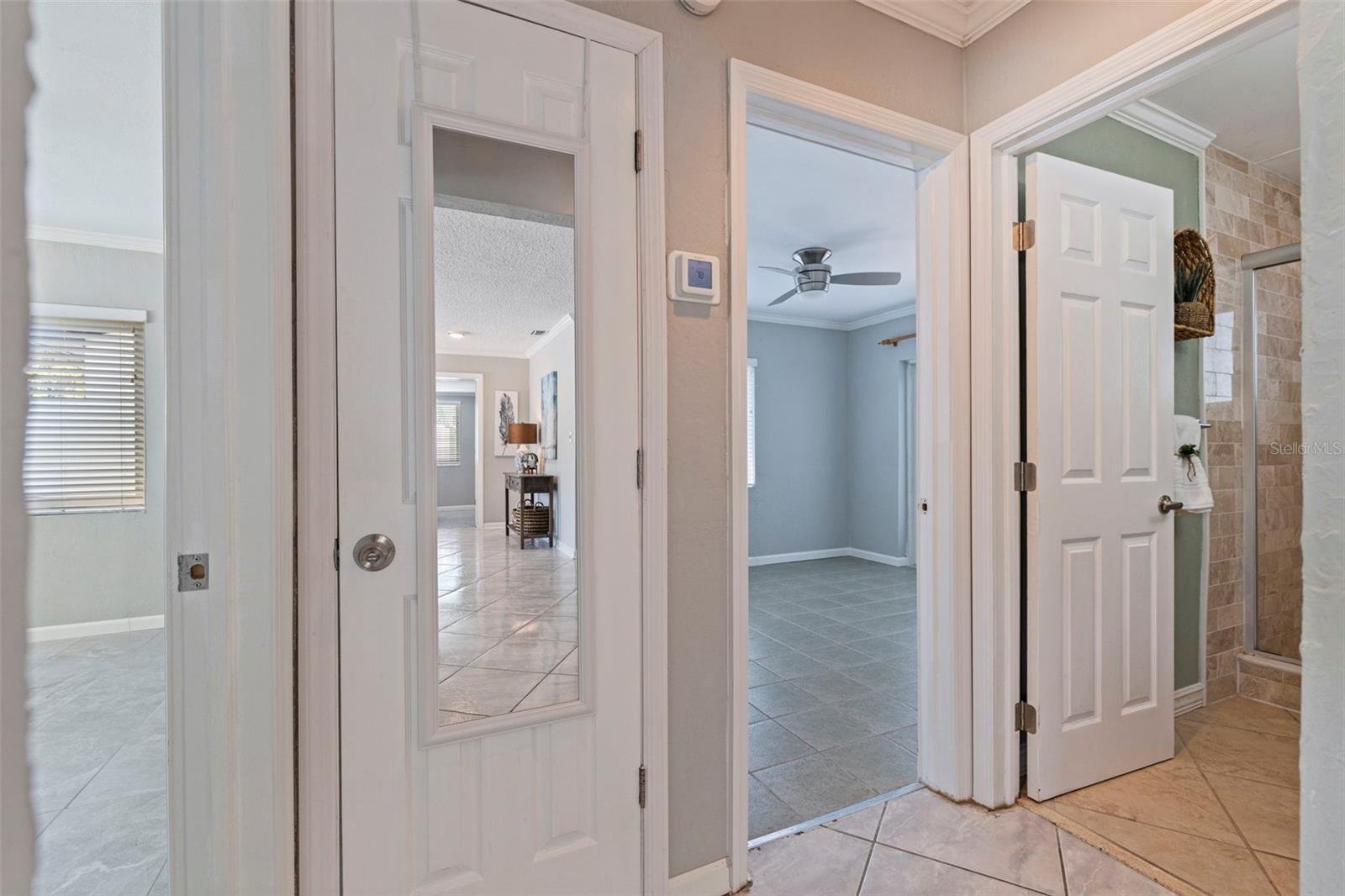 Hall on the left side of house with hall closet, 2 beds and 1 bath