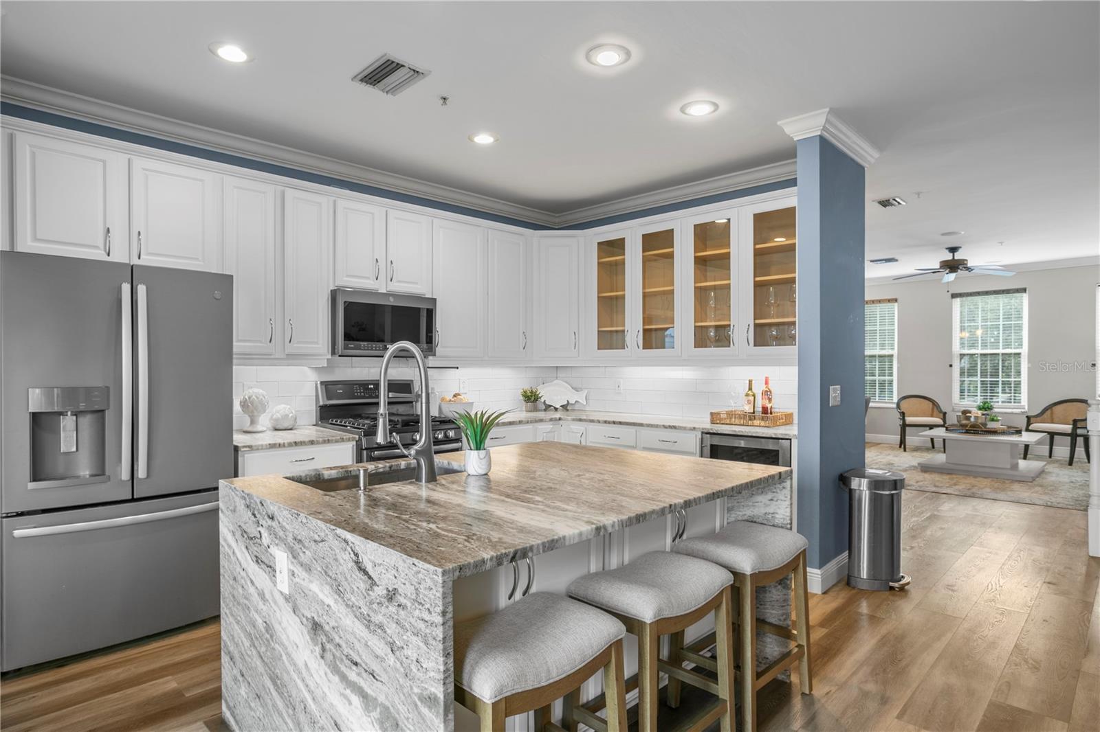 The beautifully updated eat-in kitchen withstainless steel appliances, abundant cabinetry, and a welcoming island.