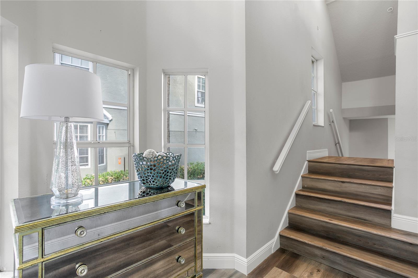 Step inside and choose your path — downstairs to a versatile bonus room, perfect for relaxing or entertaining, or upstairs to an open, light-filled living room, kitchen, and dining space designed for everyday living.